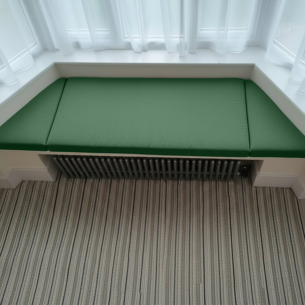 Bespoke green upholstery enhancing a cosy reading nook