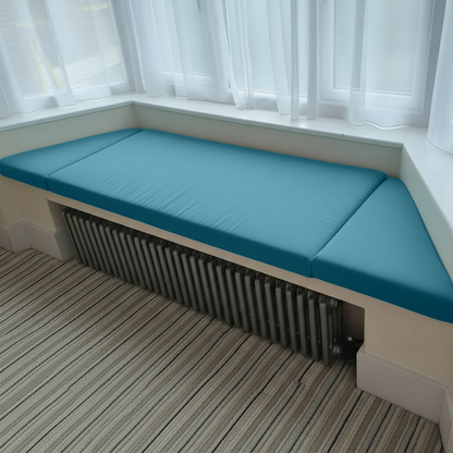 Angled bay window with aqua bespoke cushions in a 3-piece set