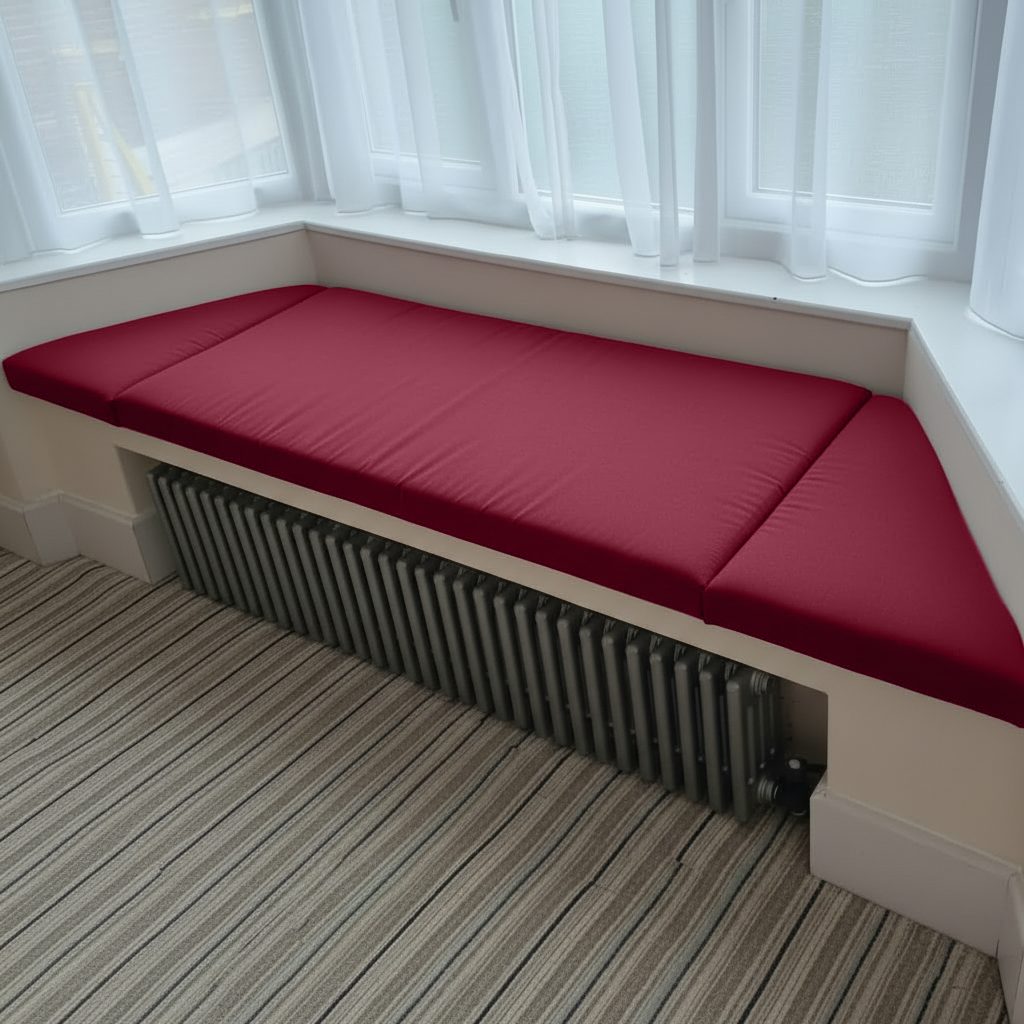 Angled bay window with bespoke Maroon cushions in a 3-piece set