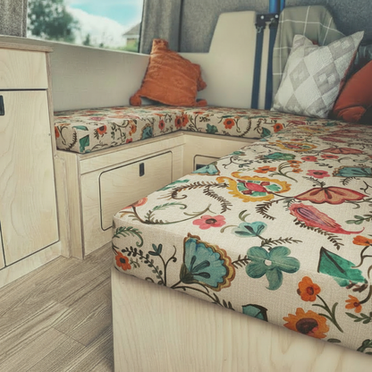 Bespoke floral pattern campervan cushions and dining seating area inside a motorhome