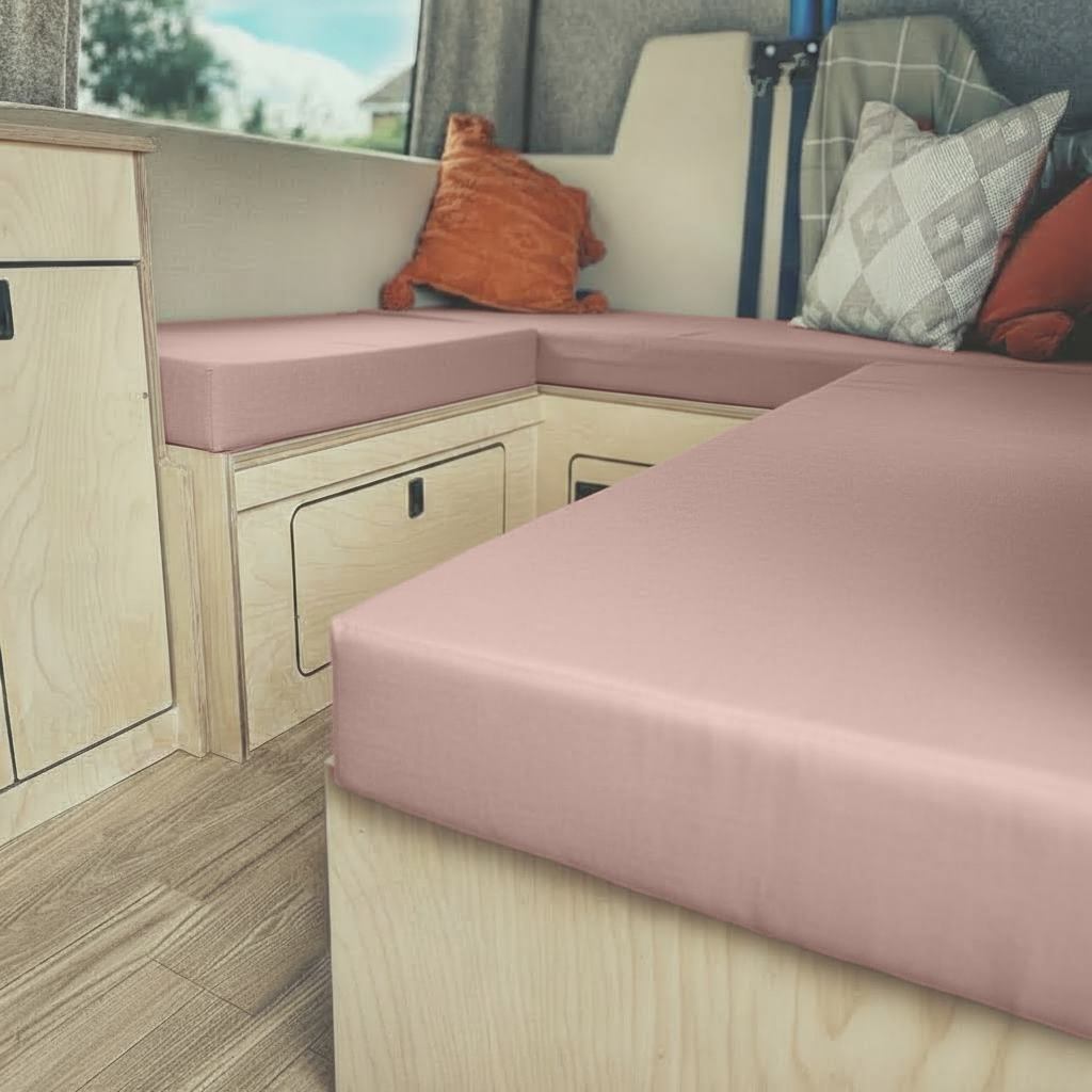 Bespoke pink motorhome upholstery on rock and roll bed
