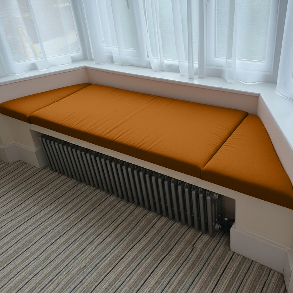 Burnt orange bay window cushions in angled three piece configuration
