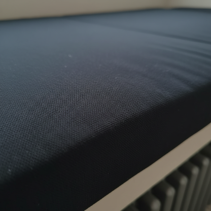 Close-up of black window seat mattress showing box edge and piping