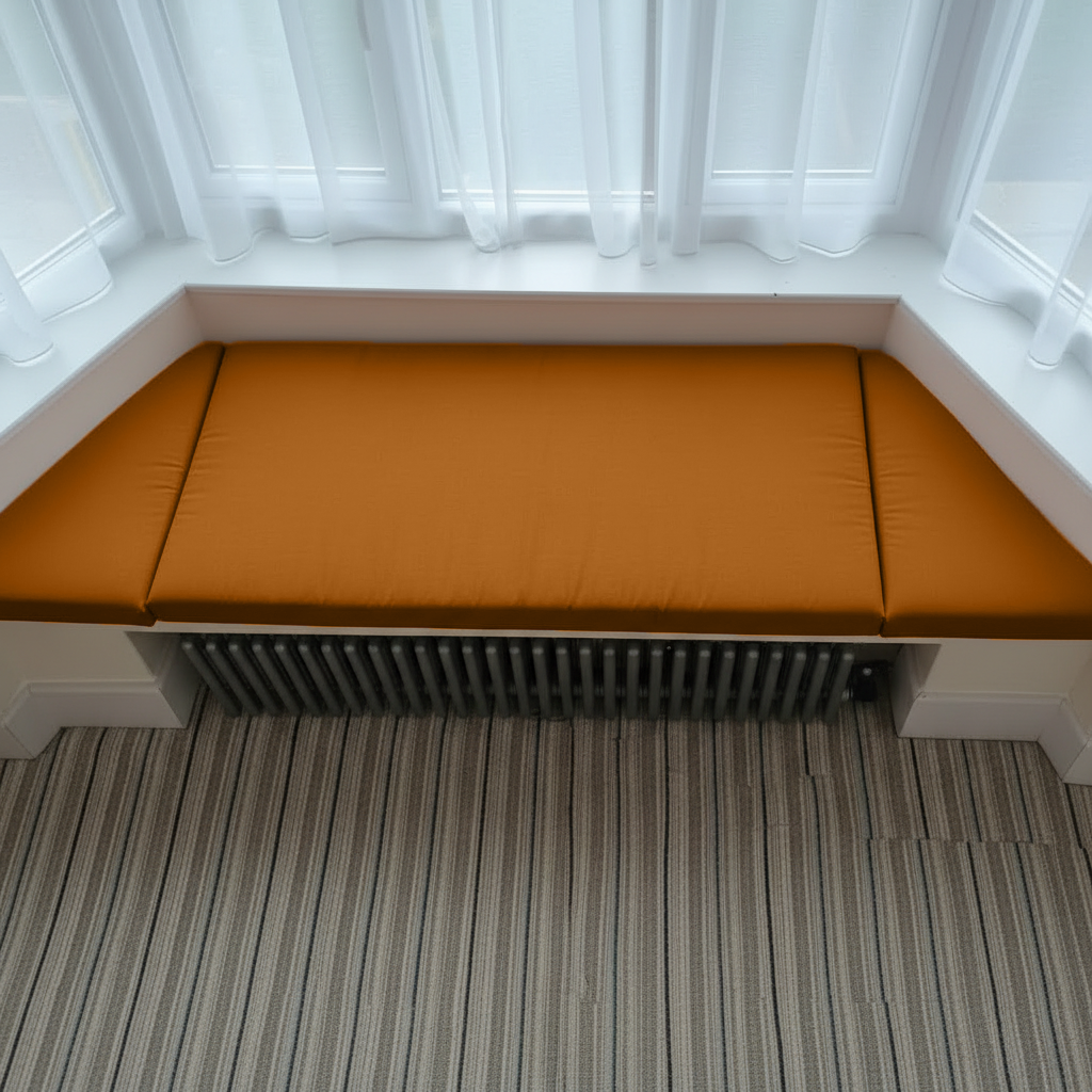 Contemporary reading nook featuring bespoke burnt orange indoor seating