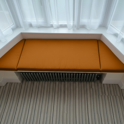 Contemporary reading nook featuring bespoke burnt orange indoor seating