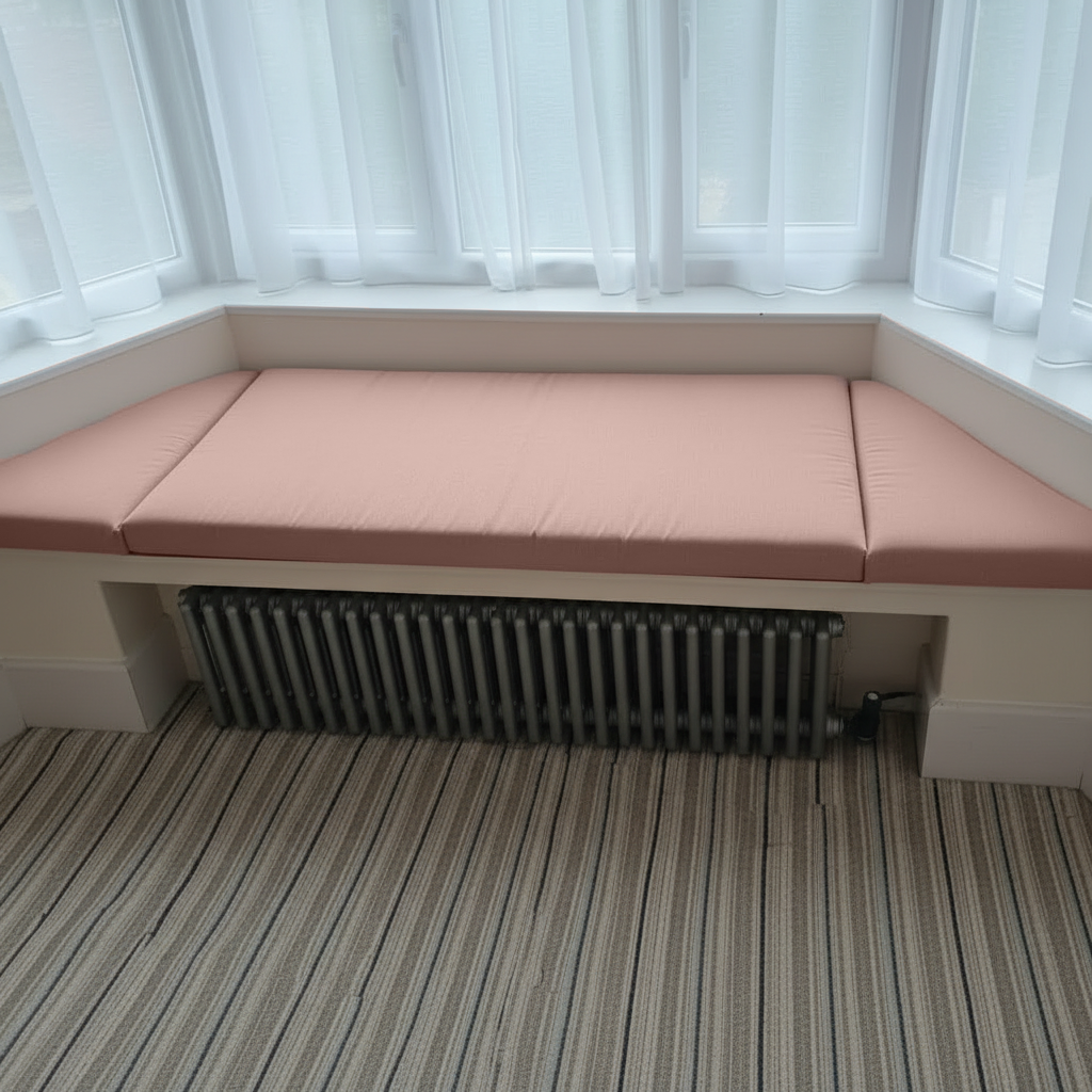 Cozy reading nook with soft pink window seat mattress set