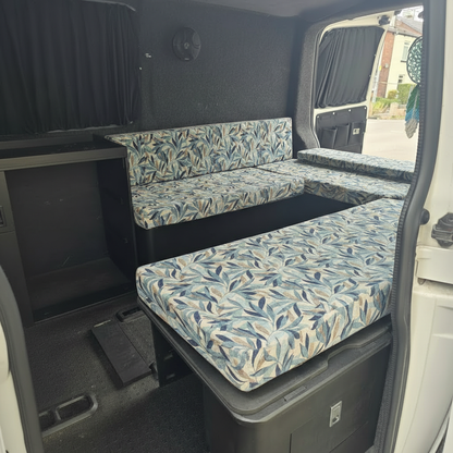 Custom made blue and beige leaf pattern campervan cushions on a slide out bed
