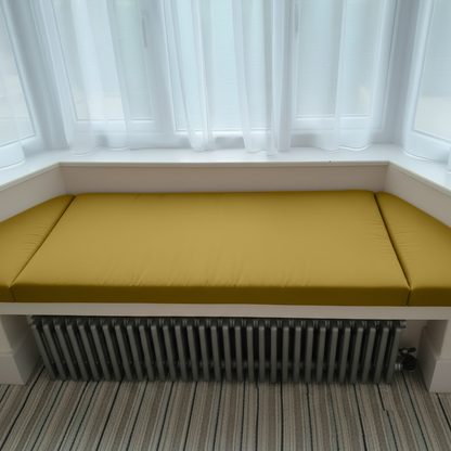 Elegant Mustard Gold cushions enhancing a reading nook