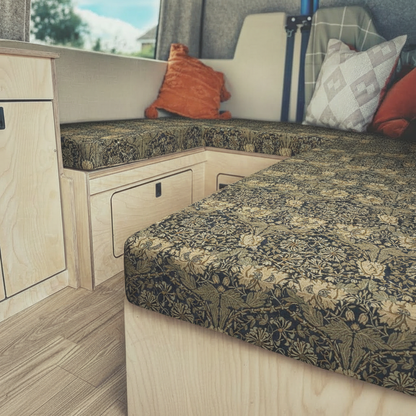Heritage dark botanical Campervan cushions in luxury interior-William Morris Style Arts & Crafts Upholstery on dining seats-Dark floral motorhome seating with gold leaf pattern-High density foam cushions for vintage caravan restoration-Moody interior design for campervan conversion
