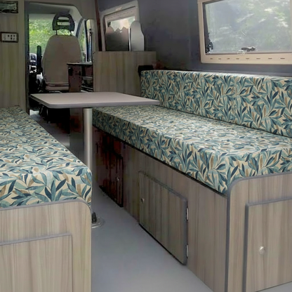 High-density caravan seating foam with modern fabric cover- Motorhome reupholstery interior with blue and green leaf design-Made-to-measure camper upholstery fitted in conversion van-Durable fabric texture for Motorhome bespoke furnishings

