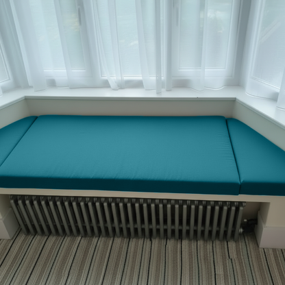 Luxury home interior showing rich teal bespoke upholstery on bay window