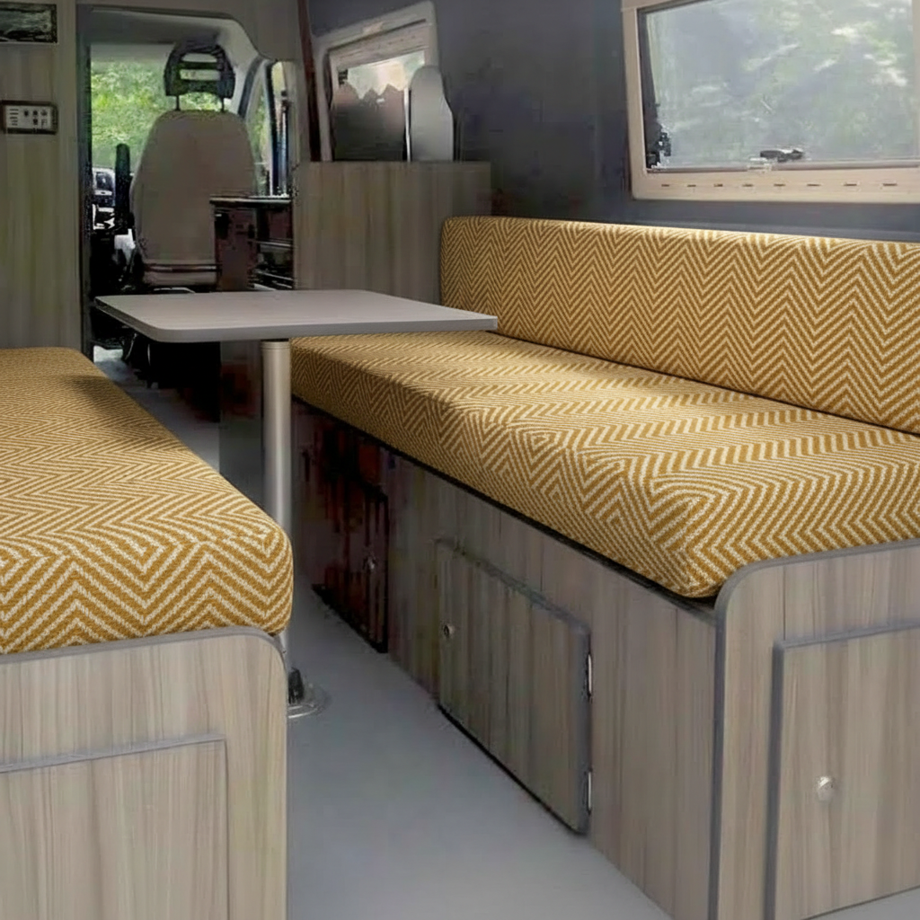 Modern herringbone Campervan cushions in mustard gold-Textured Zig-Zag motorhome seating interior view-Woven fabric detail of Scandi style van upholstery-High density foam with geometric chevron pattern-Contemporary camper conversion with gold zig zag seats