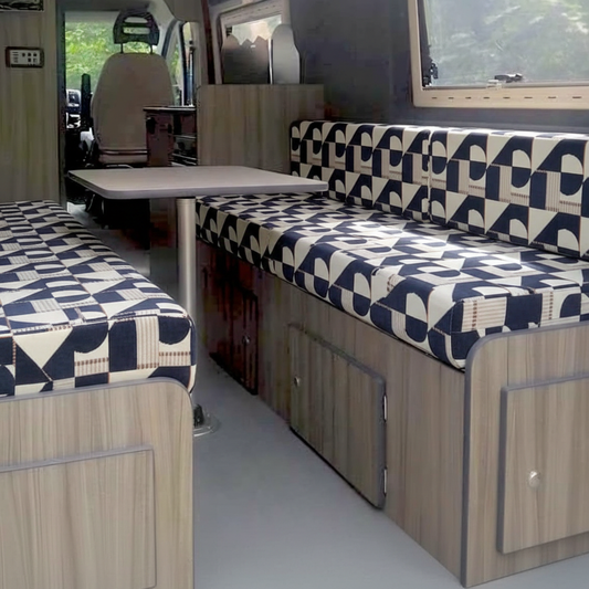Navy blue Bauhaus geometric Campervan cushions interior-Modern Abstract Upholstery on dining bench seats-Nautical style van seating with blue and cream pattern-High density foam cushions with architectural print-Contemporary coastal camper conversion design
