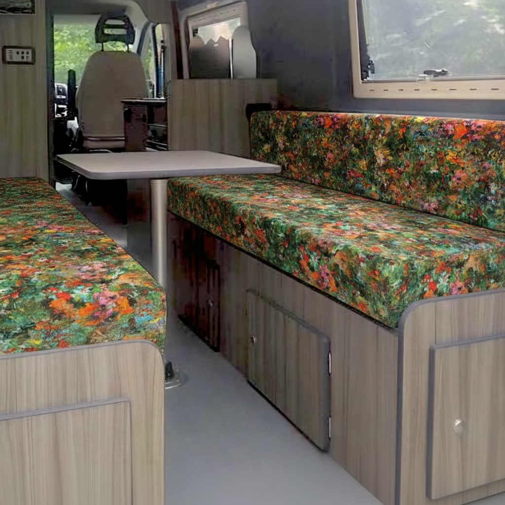 Premium campervan cushion seating with vibrant abstract floral fabric in a van conversion dinette
