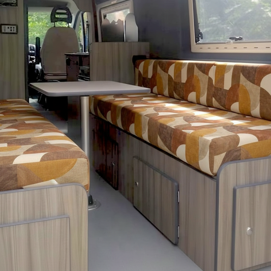 Retro geometric Campervan cushions with brown and orange pattern-Vintage style motorhome seating inside a conversion van-Geometric motorhome cushions on high density foam-Bespoke geometric van upholstery detail shot-Earth tone patterned camper seats for retro interior