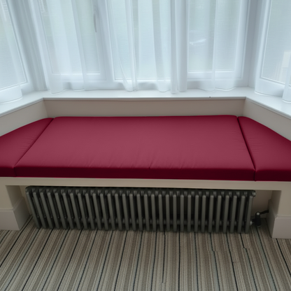 Stylish indoor seating with rich maroon bespoke bay window cushions
