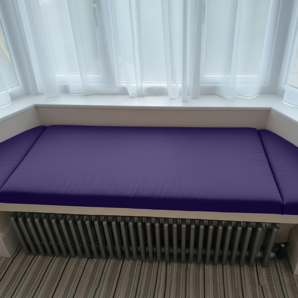 Three-piece purple bay window seat cushions neatly arranged