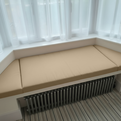Trapezoid bench pads elegantly upholstered in champagne fabric