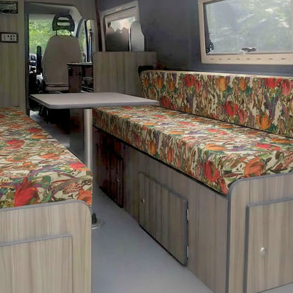 Vibrant floral Campervan seat covers in a conversion van-Custom foam pads with red tulip pattern for motorhomes-DIY van conversion cushions fitted on wooden bench-Close up of patterned Leisure vehicle upholstery fabric-Bright floral interior design for campervan renovation
