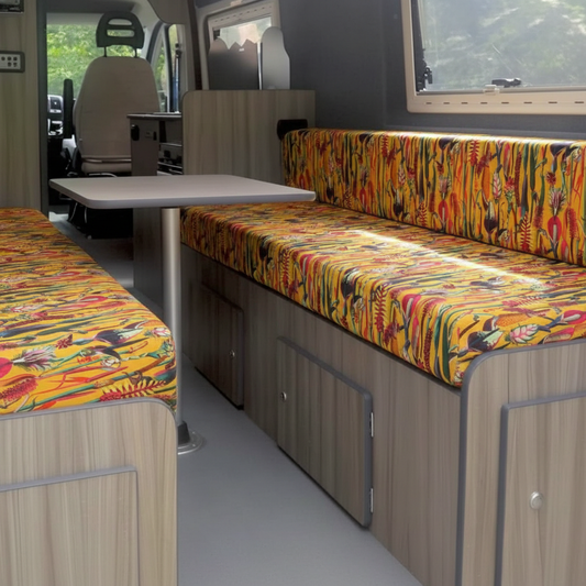 Vibrant tropical botanical Campervan cushions in yellow-Exotic yellow motorhome upholstery on dinette bench-Bright floral caravan seating with vertical pattern-High density foam cushions with tropical print-Summer style camper interior conversion
