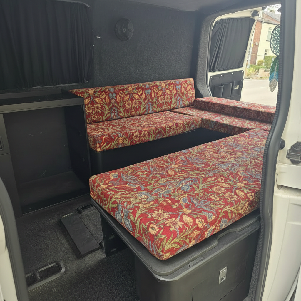 Vintage red floral tapestry style campervan cushions on a slide out bed system

