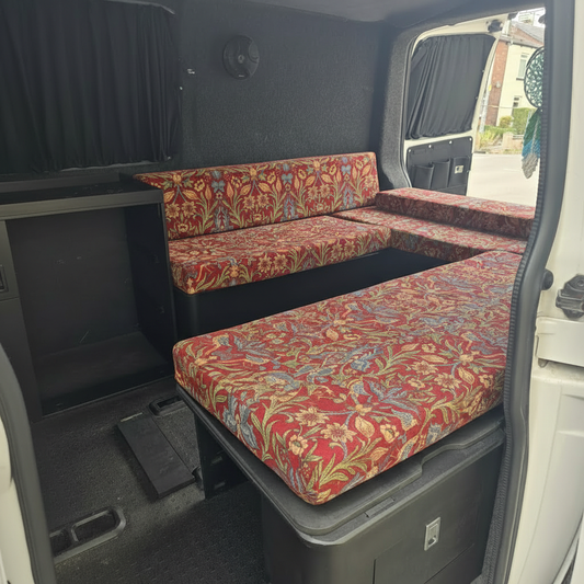 Vintage red floral tapestry style campervan cushions on a slide out bed system

