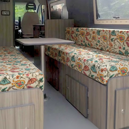 Bespoke floral pattern campervan cushions and dining seating area inside a motorhome